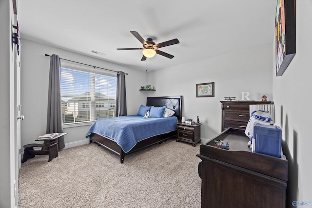 bedroom with baseboards, a ceiling fan, carpet flooring, and visible vents
