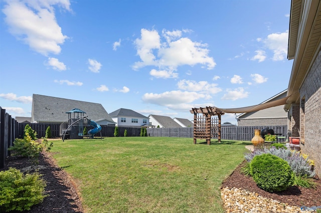 view of yard with a playground and a fenced backyard