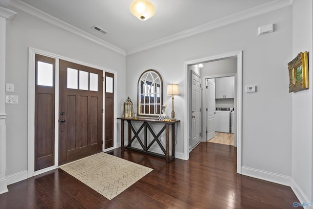 foyer featuring baseboards, ornamental molding, wood finished floors, and visible vents