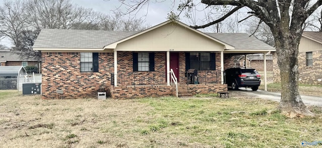 single story home with a front yard, a carport, and a porch