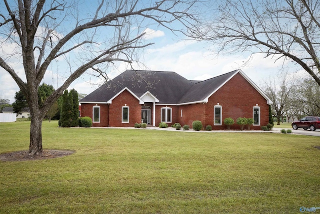 ranch-style home featuring brick siding and a front lawn