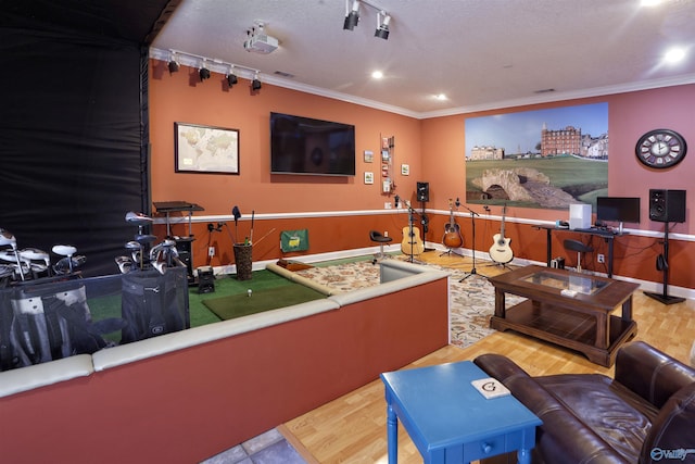home theater room featuring ornamental molding, recessed lighting, baseboards, and wood finished floors