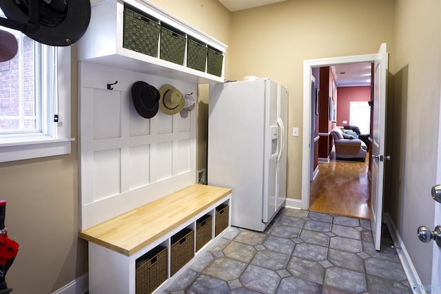 mudroom with healthy amount of natural light and baseboards