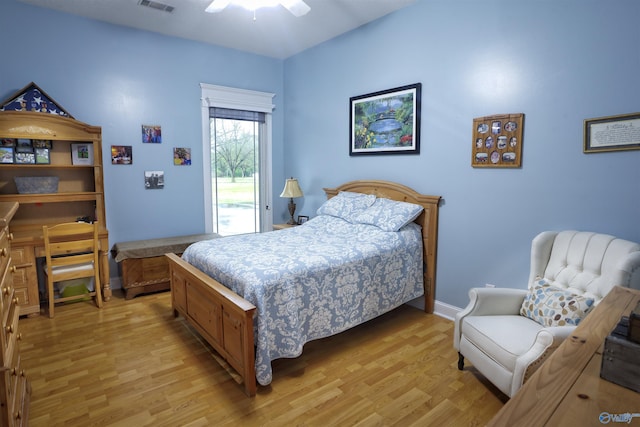 bedroom with light wood finished floors, access to outside, and a ceiling fan