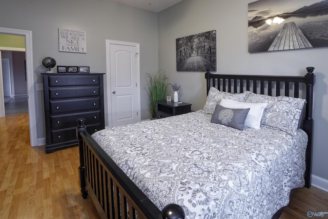 bedroom featuring wood finished floors and baseboards