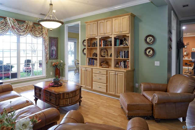 living room featuring light wood-type flooring and crown molding