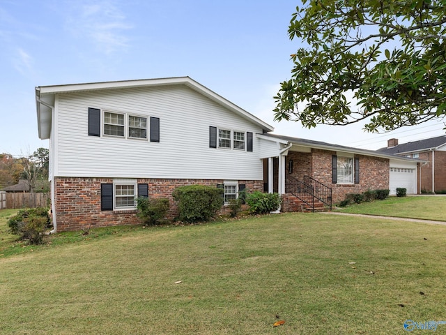 tri-level home featuring a garage and a front lawn