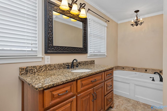 bathroom featuring a wealth of natural light, a notable chandelier, ornamental molding, a bath, and vanity