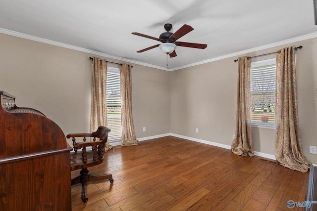 office area featuring baseboards, plenty of natural light, ornamental molding, and hardwood / wood-style flooring