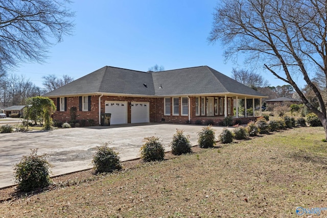 view of front facade with a garage, brick siding, and concrete driveway