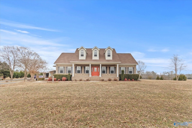 cape cod-style house featuring a front lawn