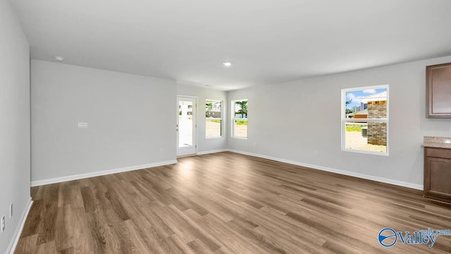 6156 Feather Way SE, Owens Cross Roads, AL 35763 - unfurnished living room featuring wood finished floors, baseboards, and recessed lighting