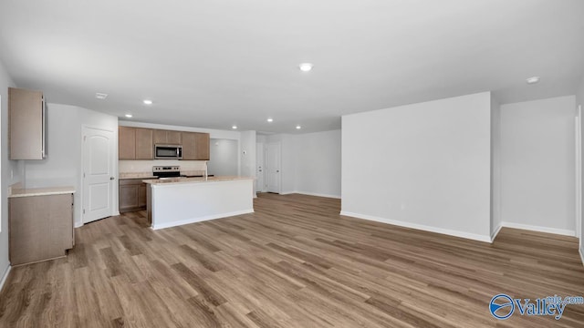 6156 Feather Way SE, Owens Cross Roads, AL 35763 - unfurnished living room with recessed lighting, baseboards, and light wood-style floors