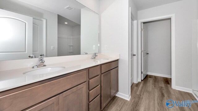 6156 Feather Way SE, Owens Cross Roads, AL 35763 - bathroom featuring wood finished floors, baseboards, and double vanity