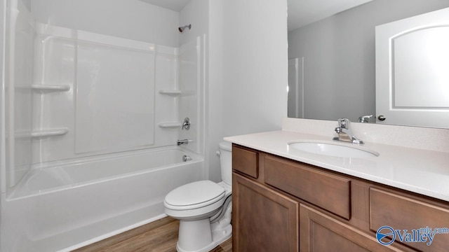 6156 Feather Way SE, Owens Cross Roads, AL 35763 - bathroom with toilet, vanity, wood finished floors, and tub / shower combination