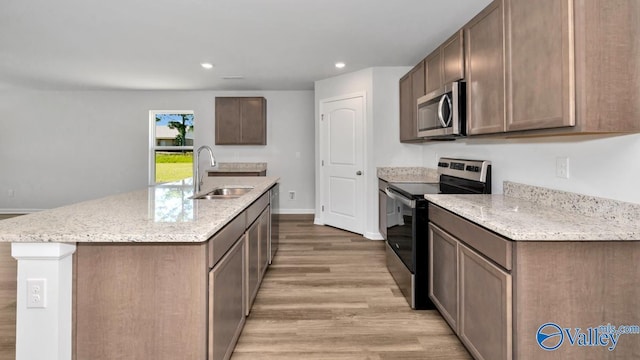 6156 Feather Way SE, Owens Cross Roads, AL 35763 - kitchen featuring appliances with stainless steel finishes, a sink, light wood finished floors, light stone countertops, and recessed lighting