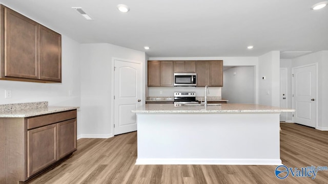 6156 Feather Way SE, Owens Cross Roads, AL 35763 - kitchen with stainless steel appliances, light wood finished floors, baseboards, a sink, and recessed lighting