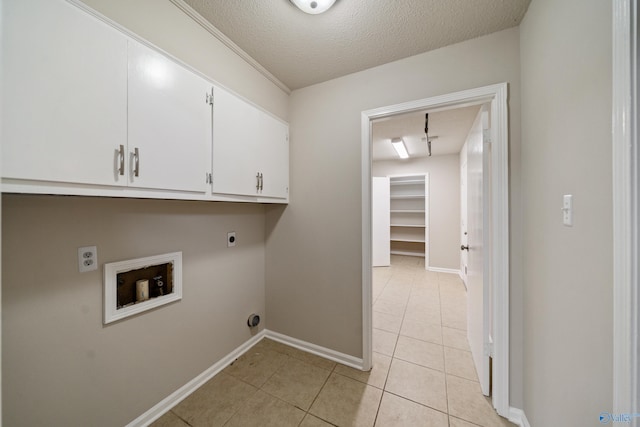 washroom featuring hookup for an electric dryer, cabinet space, baseboards, hookup for a washing machine, and light tile patterned flooring