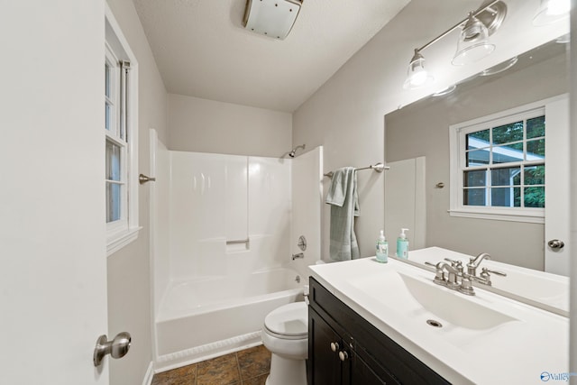 bathroom with vanity, tub / shower combination, and toilet
