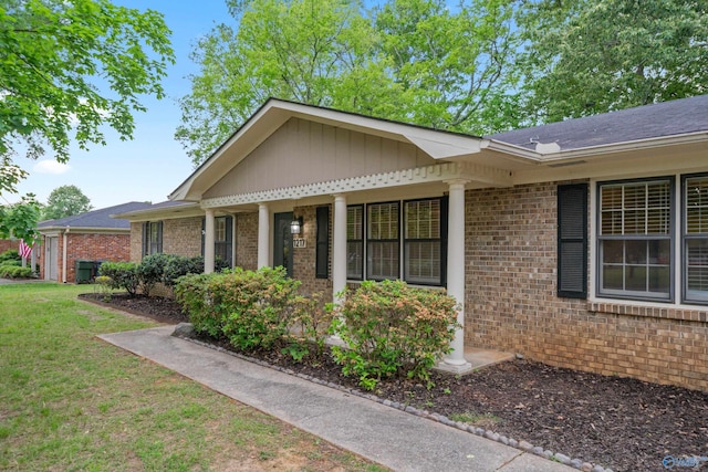 exterior space featuring a lawn and brick siding