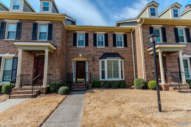 townhome / multi-family property with brick siding