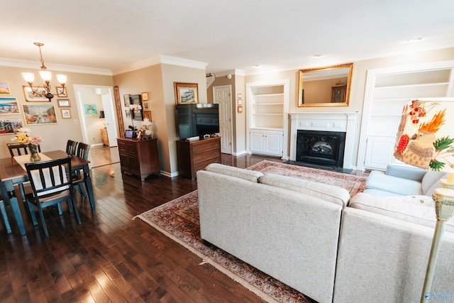 235 Inverness Dr Unit 235, Huntsville, AL 35802 - living area featuring a fireplace with flush hearth, crown molding, dark wood finished floors, and an inviting chandelier