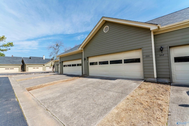 garage with concrete driveway