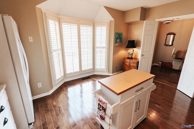 235 Inverness Dr Unit 235, Huntsville, AL 35802 - kitchen with dark wood-style flooring, freestanding refrigerator, white cabinetry, wood counters, and baseboards