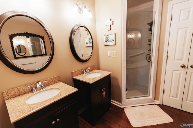 235 Inverness Dr Unit 235, Huntsville, AL 35802 - bathroom with two vanities, a sink, a shower stall, and wood finished floors