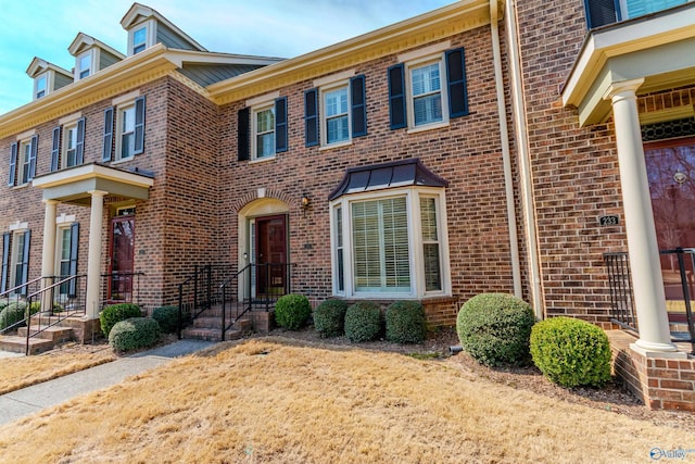 townhome / multi-family property featuring brick siding