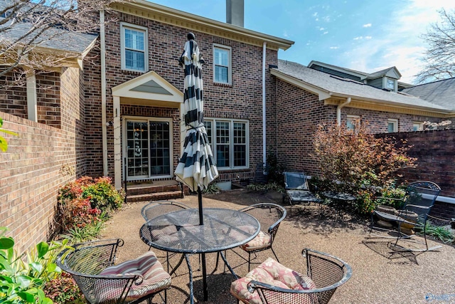 235 Inverness Dr Unit 235, Huntsville, AL 35802 - rear view of house with entry steps, brick siding, a patio area, and fence