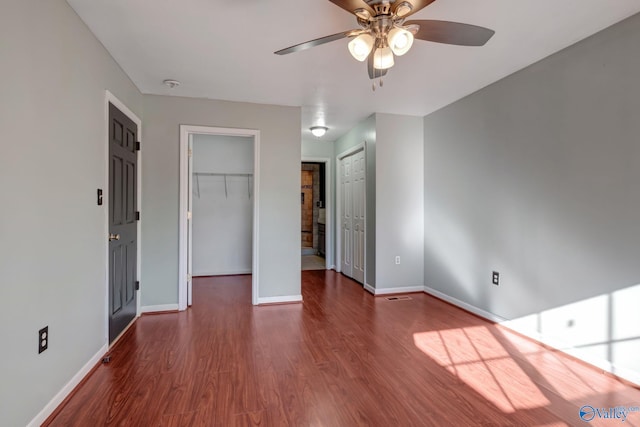 unfurnished bedroom featuring hardwood / wood-style floors and ceiling fan