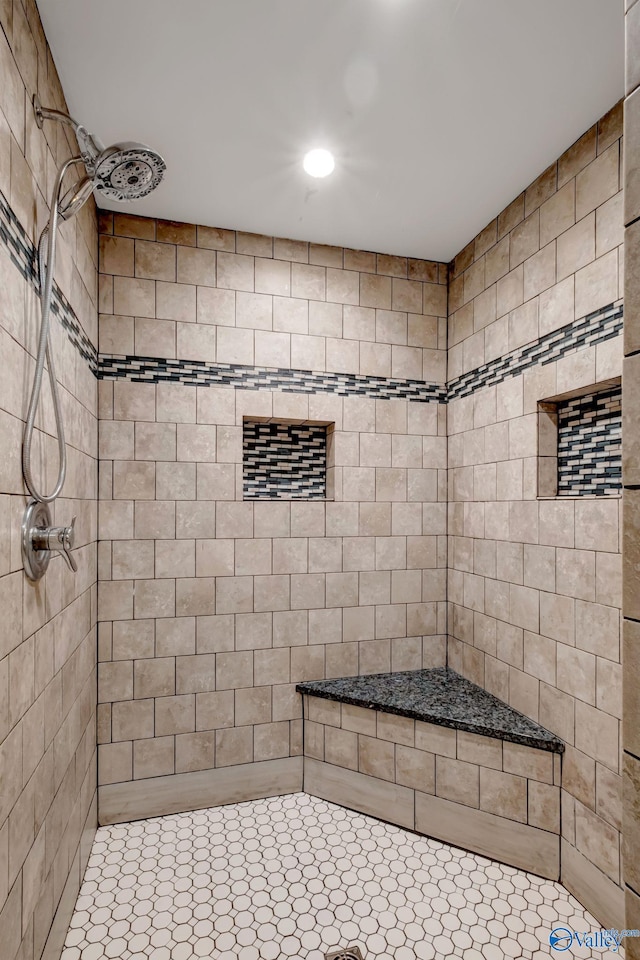 bathroom with a tile shower