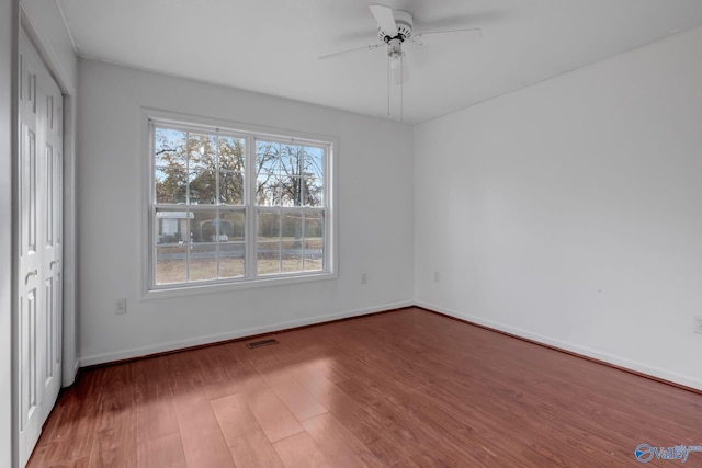 unfurnished bedroom with ceiling fan and hardwood / wood-style flooring