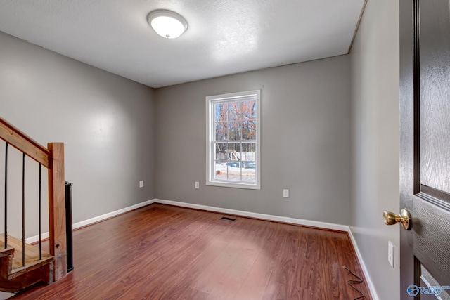 empty room with wood-type flooring