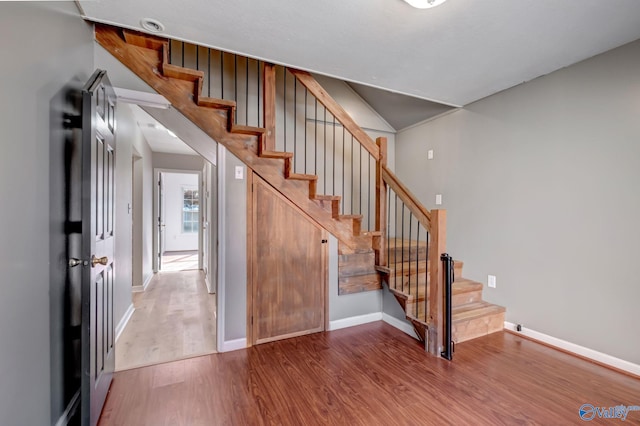 stairway featuring hardwood / wood-style flooring