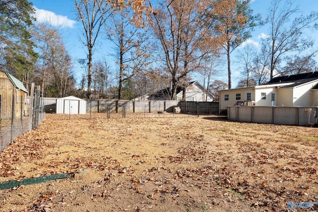 view of yard featuring a storage unit and a pool