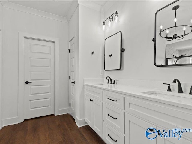23819 Justin Brent Cir, Elkmont, AL 35620 - full bath with double vanity, wood finished floors, and a chandelier