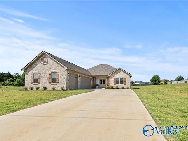 23819 Justin Brent Cir, Elkmont, AL 35620 - view of front of property with brick siding, an attached garage, concrete driveway, and a front lawn