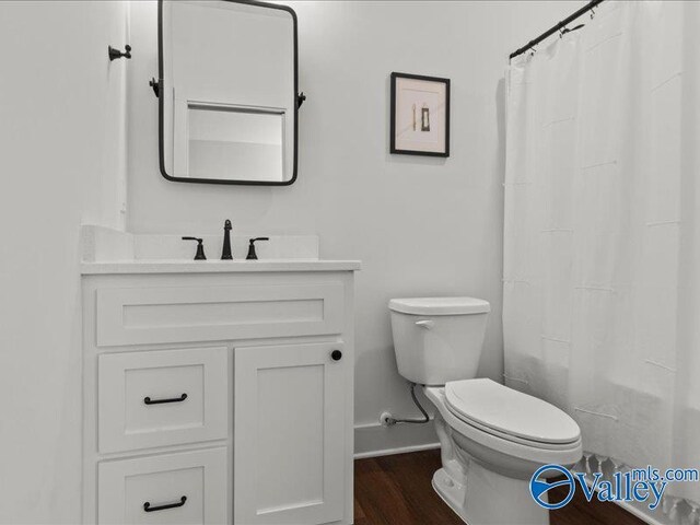 23819 Justin Brent Cir, Elkmont, AL 35620 - bathroom featuring baseboards, vanity, toilet, and wood finished floors