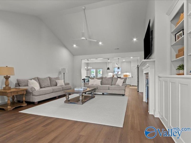 23819 Justin Brent Cir, Elkmont, AL 35620 - living area featuring a chandelier, dark wood finished floors, high vaulted ceiling, and a ceiling fan