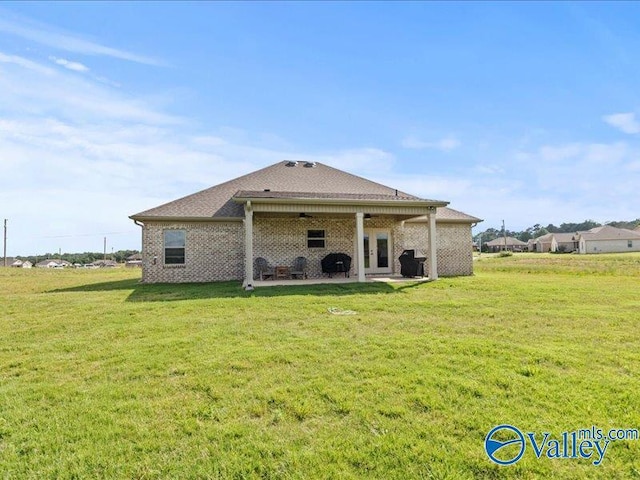 23819 Justin Brent Cir, Elkmont, AL 35620 - back of property with a patio area, a lawn, ceiling fan, and brick siding