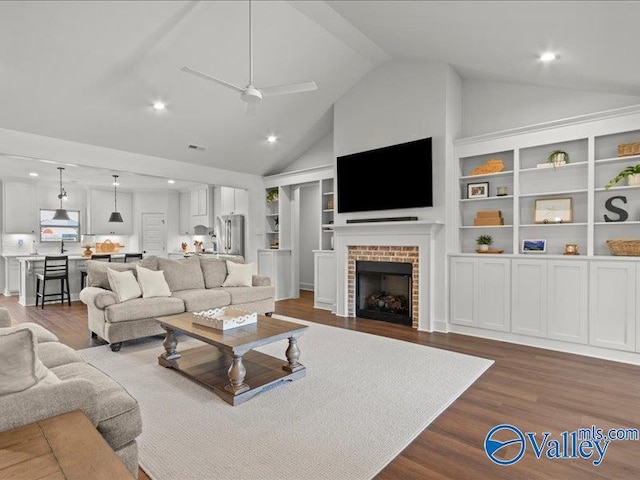 23819 Justin Brent Cir, Elkmont, AL 35620 - living area with a brick fireplace, dark wood-style floors, ceiling fan, high vaulted ceiling, and recessed lighting