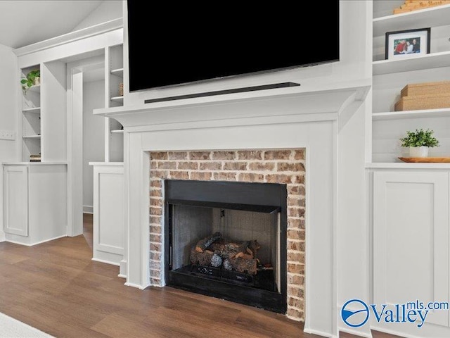 23819 Justin Brent Cir, Elkmont, AL 35620 - detailed view of a fireplace, wood finished floors, and built in shelves