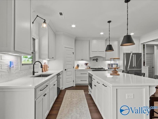 23819 Justin Brent Cir, Elkmont, AL 35620 - kitchen featuring stainless steel appliances, backsplash, light countertops, white cabinetry, and recessed lighting