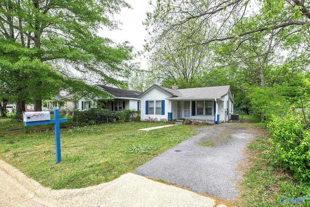 505 Mccullough Ave NE, Huntsville, AL 35801 - ranch-style home with central AC unit, a chimney, driveway, fence, and a front yard
