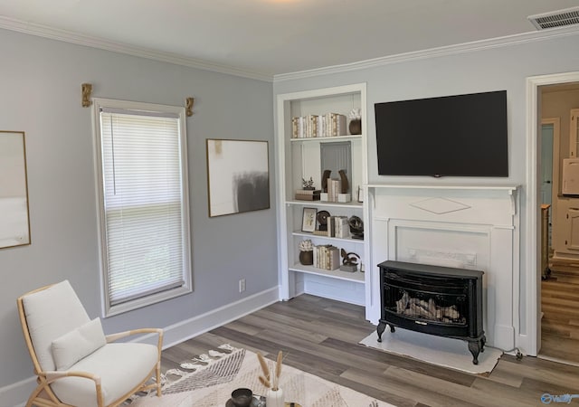 505 Mccullough Ave NE, Huntsville, AL 35801 - living area featuring wood finished floors, visible vents, baseboards, and ornamental molding