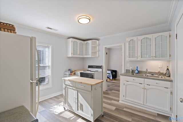 505 Mccullough Ave NE, Huntsville, AL 35801 - kitchen featuring white cabinets, light wood-style flooring, a sink, glass insert cabinets, and white appliances