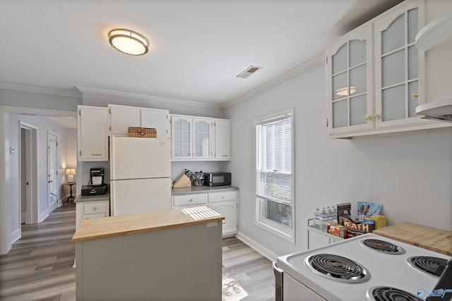 505 Mccullough Ave NE, Huntsville, AL 35801 - kitchen with wood finished floors, wood counters, white appliances, glass insert cabinets, and ornamental molding