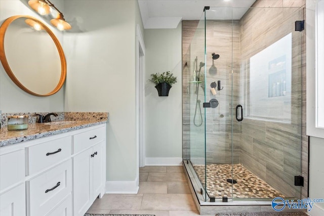 bathroom with tile patterned floors, vanity, and a shower with shower door